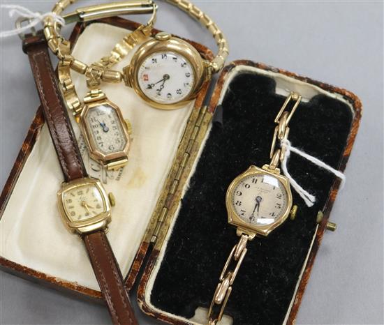 A ladys 9ct gold wrist watch on expanding bracelet and three other ladys watches.